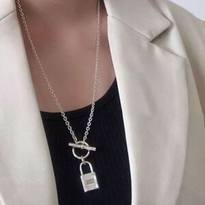The Lock It Down Long silver necklace with lock and toggle closure